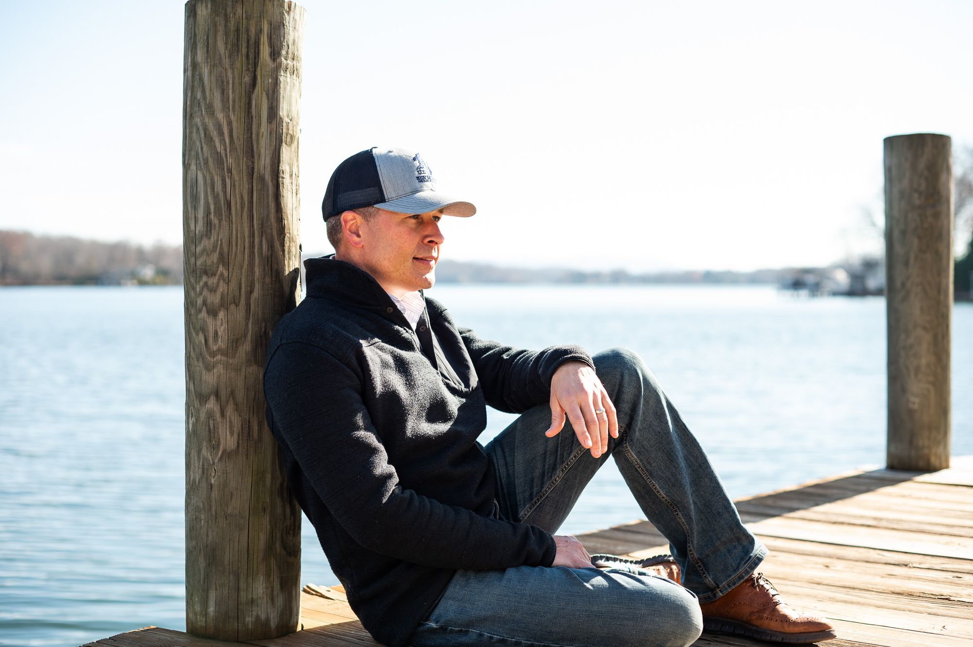 Whitney Sewell sitting on a dock by the water
