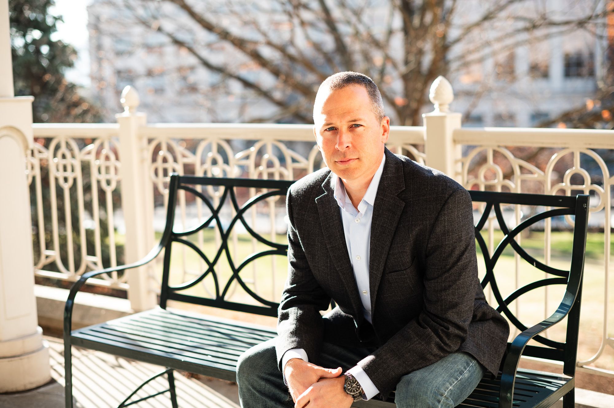Whitney Sewell seated on a bench downtown